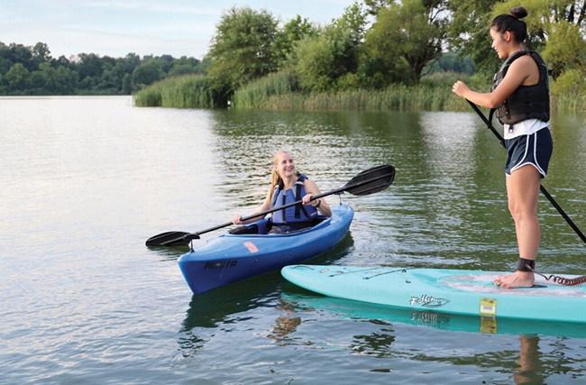 two friends paddling on a lake