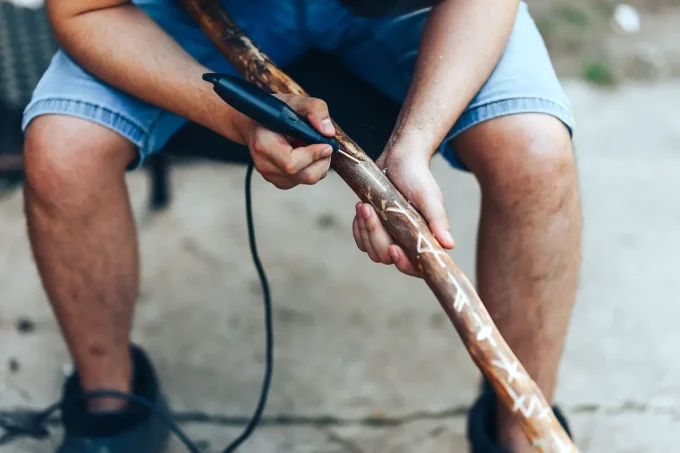 adding finishing touches to walking stick