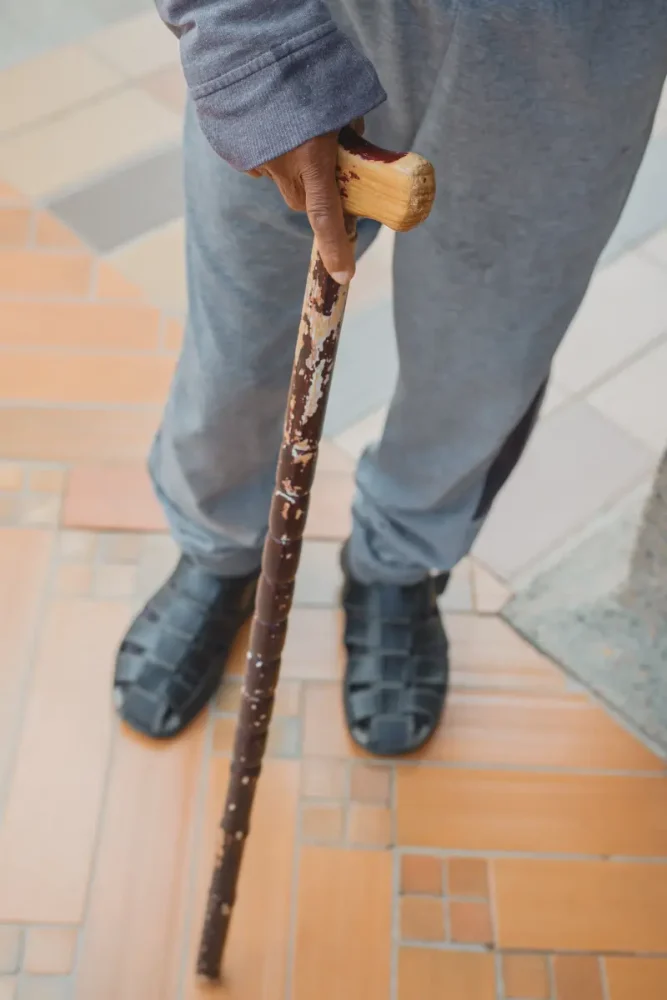 old man with DIY walking stick