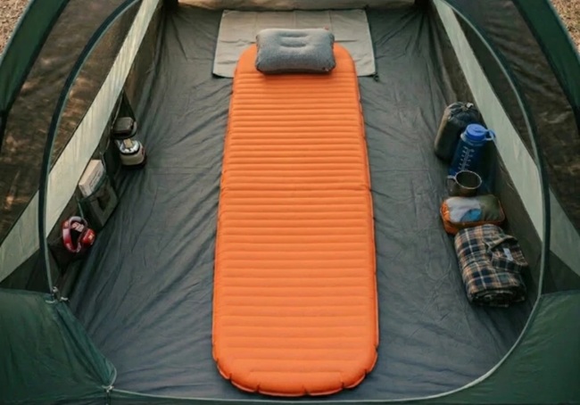 Sleeping bag on an insulated sleeping pad inside a tent