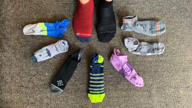 Selection of the best running socks laid out with running shoes