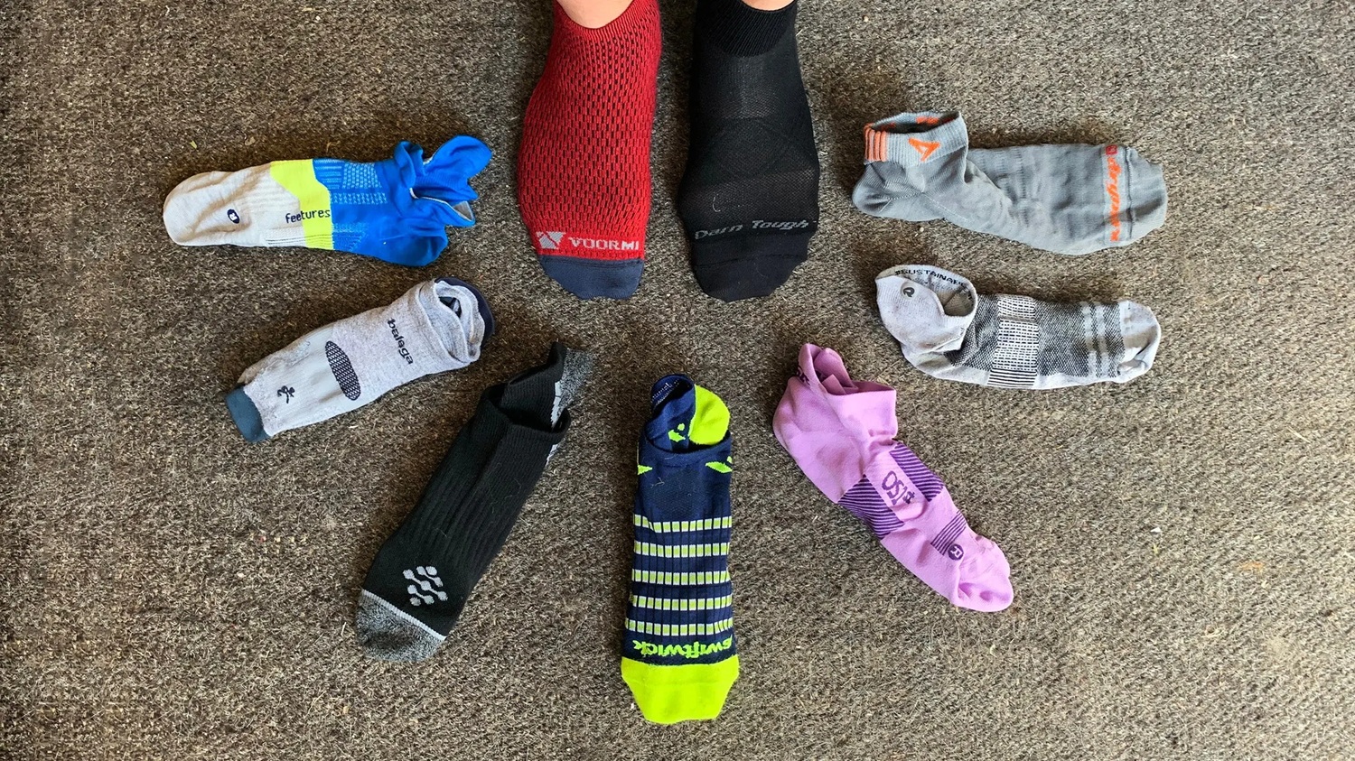 Selection of the best running socks laid out with running shoes